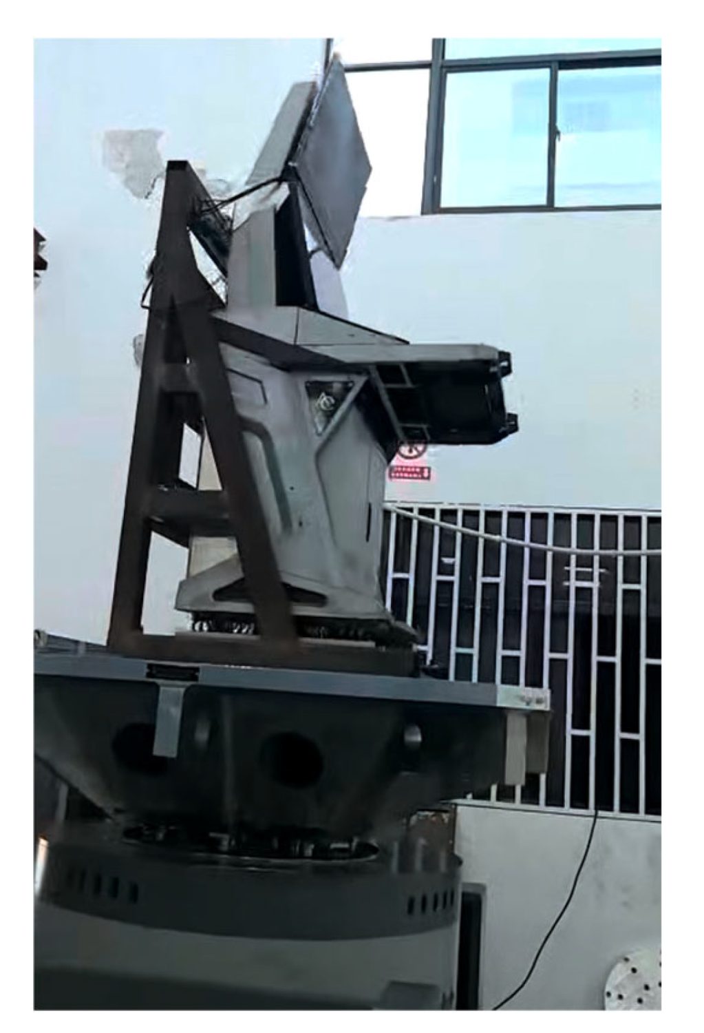The finished console bolted to the shaker table through its fixture, displays and payload fitted, ready for the vertical-axis run.