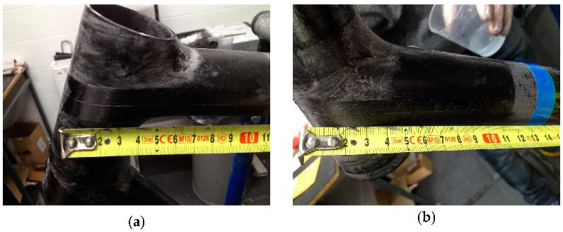 The head tube joint during hand lamination, with the optical fiber FBG sensor routed by hand across the joint and taped in position before the carbon plies close over it.